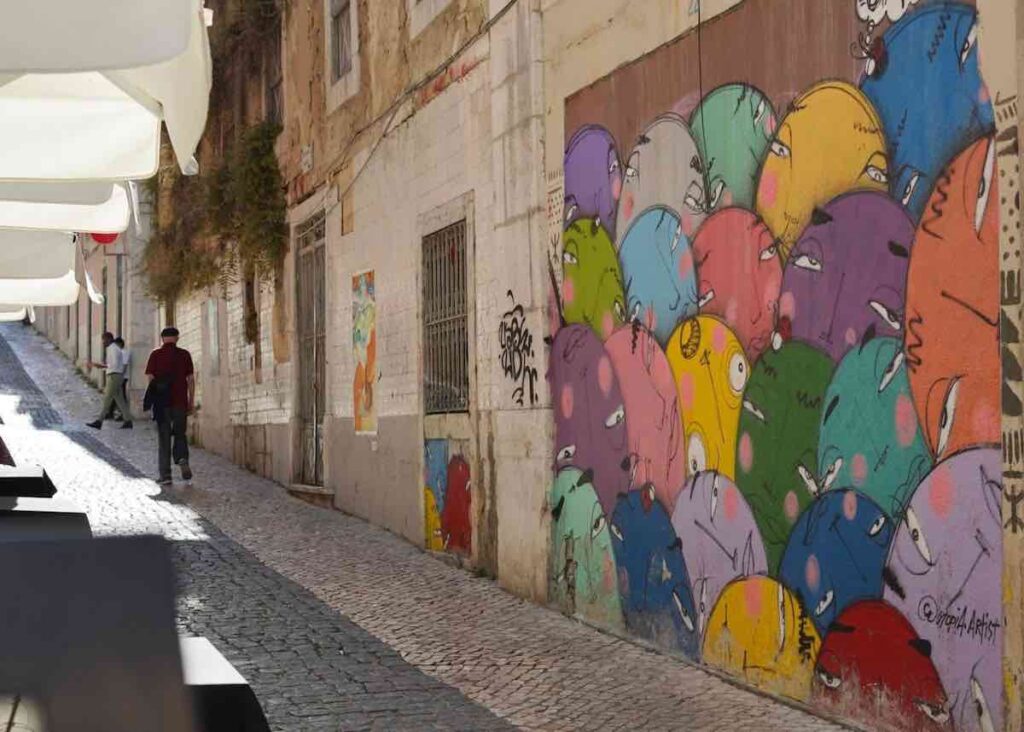 Colourful street art in the side street of Lisbon