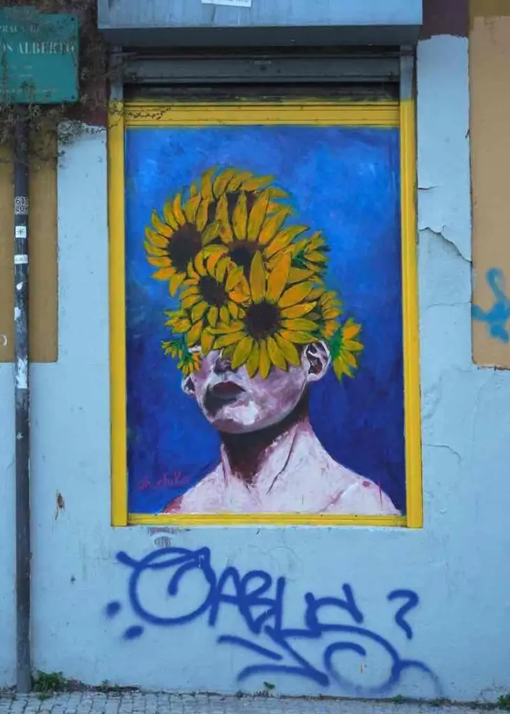 Crazy street art running tour of sunflower face in Lisbon