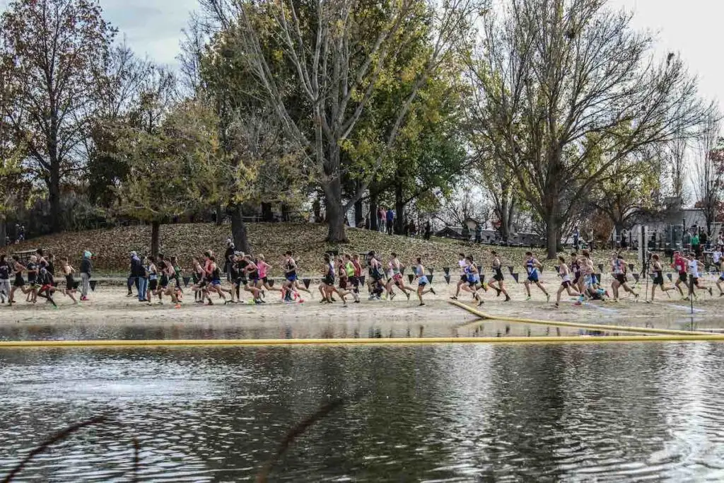 Run club running together next to a lake