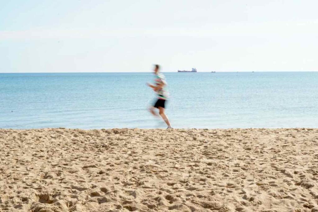 Runner by the sea on an empty beach