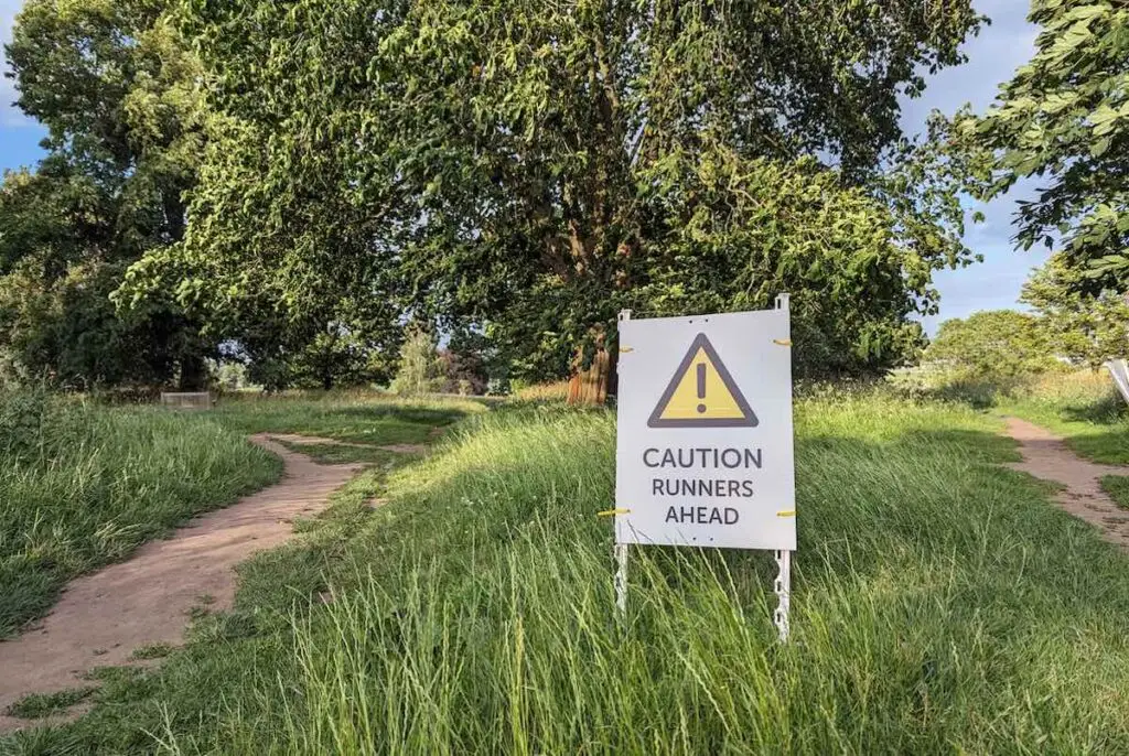 Sign warning runners are ahead