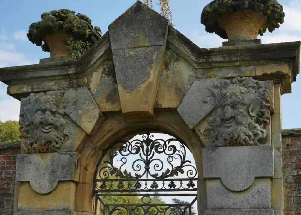 Funny face carved into stone gate