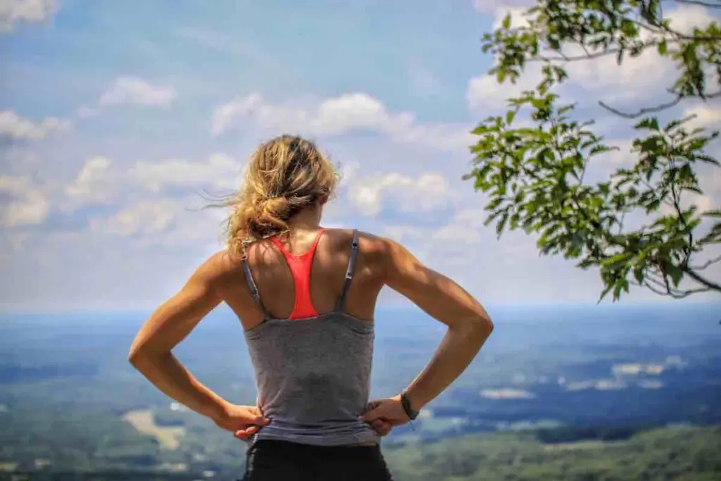 Female runner on top of a mountain